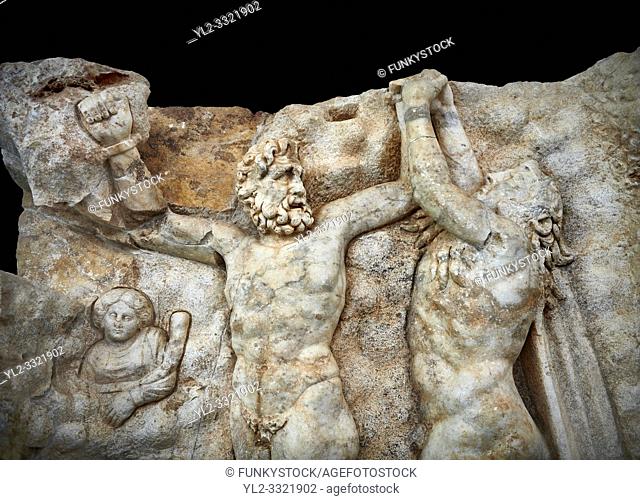 Close up of a Roman Sebasteion relief sculpture of Zeus and Prometheus, Aphrodisias Museum, Aphrodisias, Turkey. Against a black background.