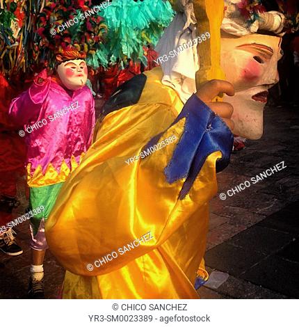 Men wearing masks and dressed in bright colors dance during the annual pilgrimage to the Our Lady of Guadalupe basilica in Mexico City, Mexico