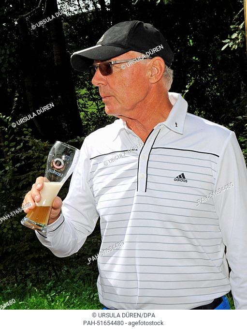German soccer legend Franz Beckenbauer smiles as he drinks a glas of beer during 'Kaiser Trophy' golf tournament as part of the 'Camp Beckenbauer' event in...