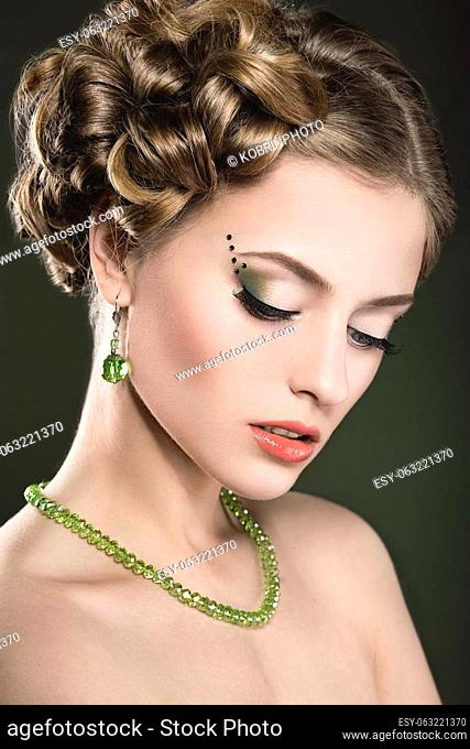 Beautiful girl with bright fashionable make-up and long thick hair. Beauty face. Photo taken in the studio