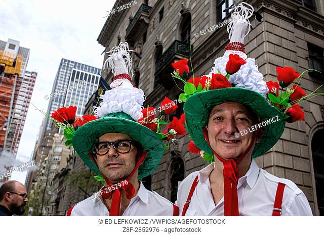 New York, NY - April 16, 2017. Two men wear hats topped in white doves, with signs reading ""Peace in the World"", at New York's annual Easter Bonnet Parade and...