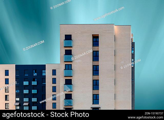 Madrid, Spain - August 31, 2019: Modern residential building against blue sky. Valdebebas new development area. Long exposure