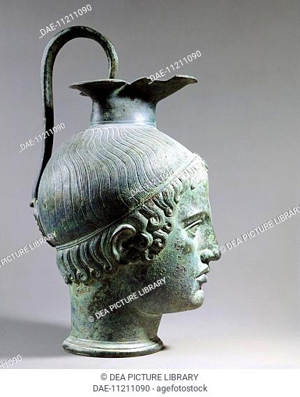 Bronze oinochoe in the shape of a young head, front view. Etruscan civilization, 425-400 BC.  Paris, Musée Du Louvre