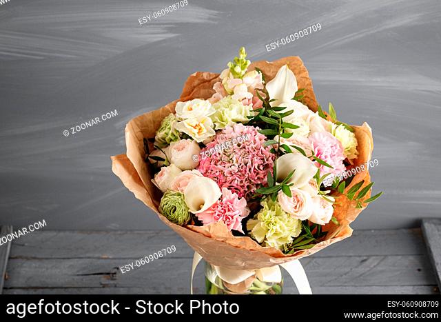 Bouquet of roses and Other colors flowers on wooden background, copy space