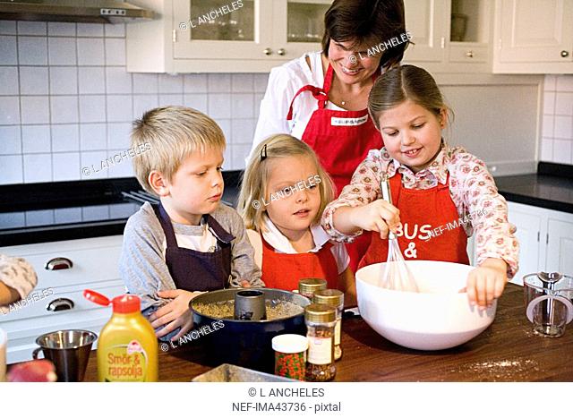 Mother and children baking