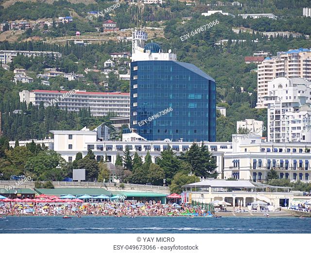 high glass hotel complex on the seafront with a full-fledged beach