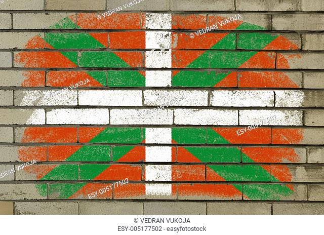 grunge flag of basque on brick wall painted with chalk