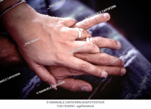 Hands of man and woman close together