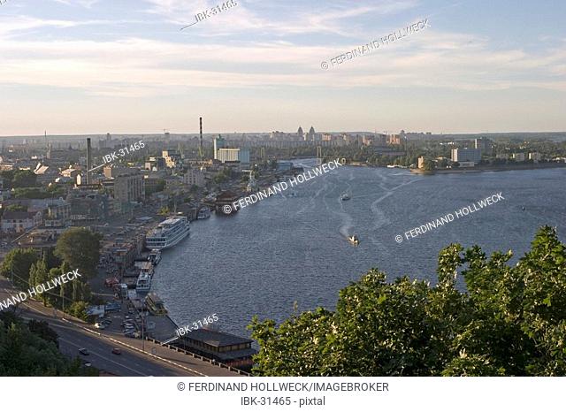 Ukraine Kiev view to a part of the city Podil landing place ships river Dnepr trees buildings city view at the river Dnepr sunset 2004