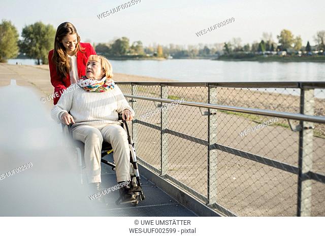 Germany, Baden-Wurttemberg, Mannheim, Granddaughter spending time with garndmother in wheelchair