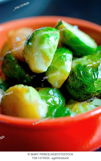 Brussel sprouts in an orange bowl