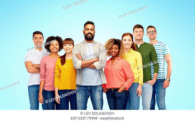diversity, race, ethnicity and people concept - international group of happy smiling men and women over blue background