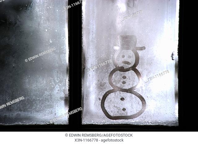 Snowman image on frosty window