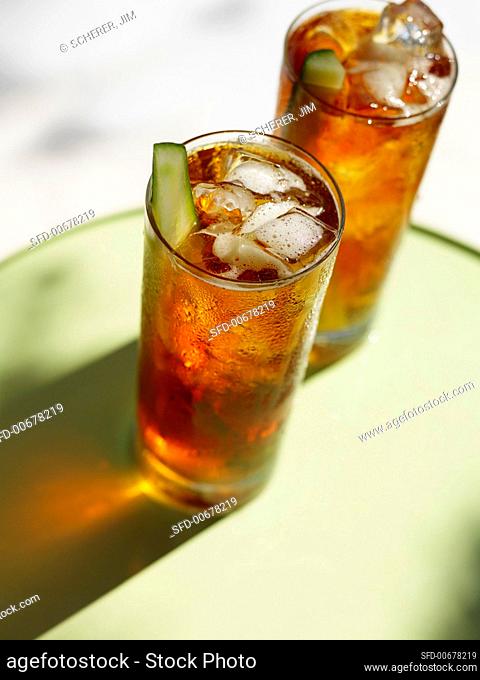 Two Tall Glasses of Pimm's with Cucumber Garnish