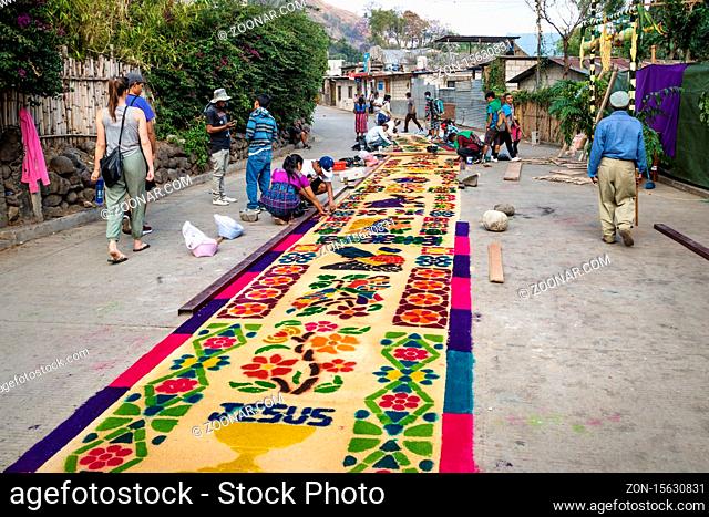 San Marcos La Laguna, Lago de Atitlan, Guatemala - 30 March 2018: Local people making alfombra, colorful sawdust carpets with Jesus and flowers for Semana Santa