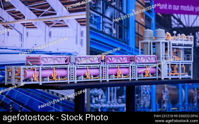 18 December 2023, North Rhine-Westphalia, Dortmund: A model of an electrolyser module stands on a table before the start of the balance sheet press conference...