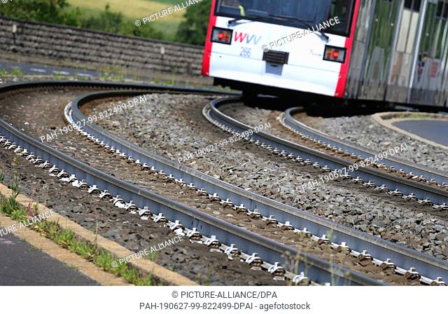 27 June 2019, Bavaria, Würzburg: The tram tracks of line 5 are painted white over a distance of about one kilometre. The light coating reduces the temperature...