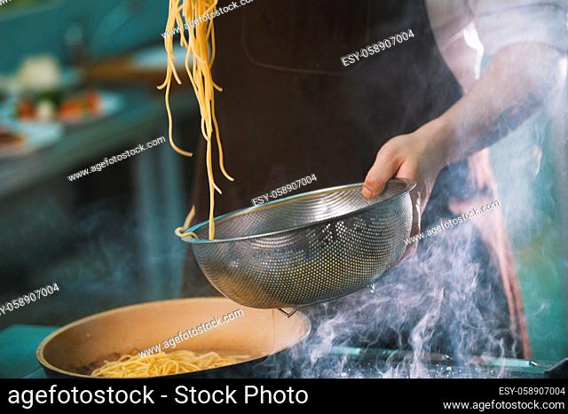 Process of cooking spaghetti in restaurant close-up