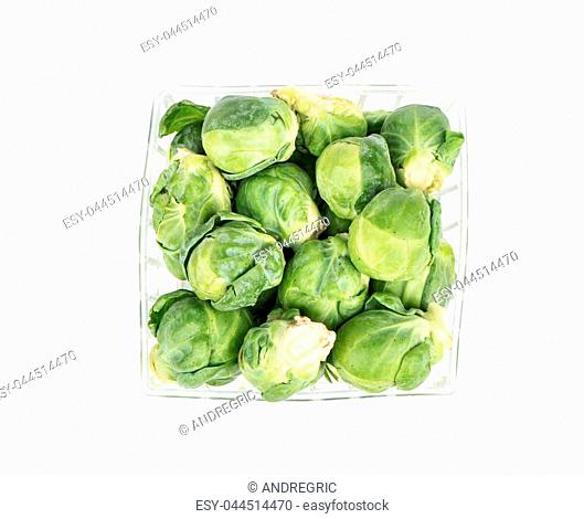 Fresh brussels sprouts in a box on a white background, top view