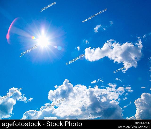 star-shaped sun in blue sky with light clouds