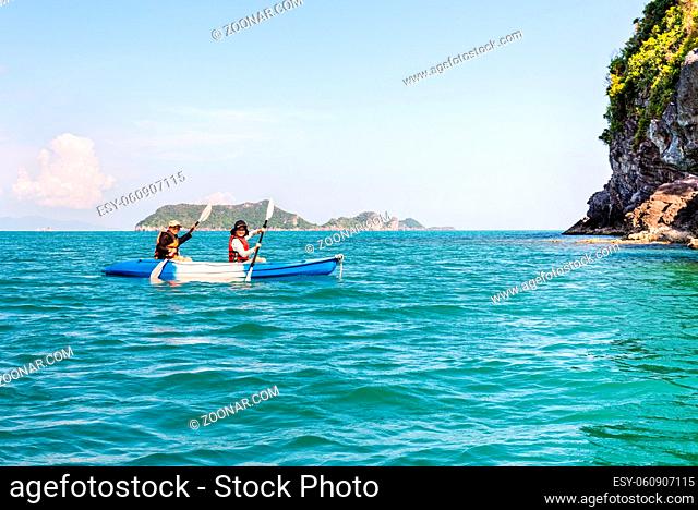 Two women are mother and daughter. Travel by boat with a kayak happy under the blue sky summer around Ko Phi view the beautiful nature of the sea and island