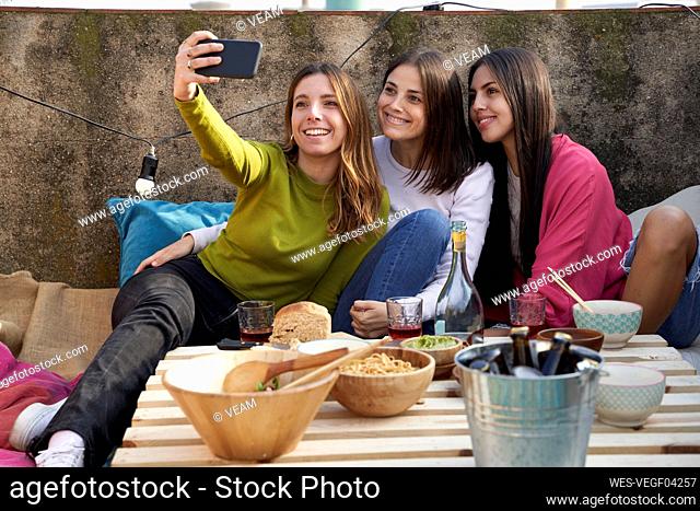 Female friends taking selfie on rooftop