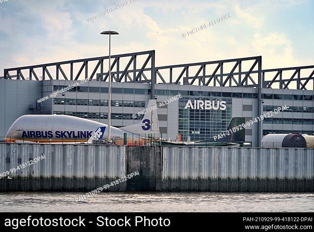 15 August 2021, Hamburg: An Airbus Skylink 3 stands as a museum piece in front of one of Airbus' production halls in Finkenwerder