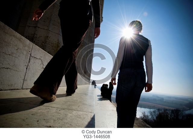 Two women walking along steps of Walhalla temple with Danube river in background, Regensburg, Germany