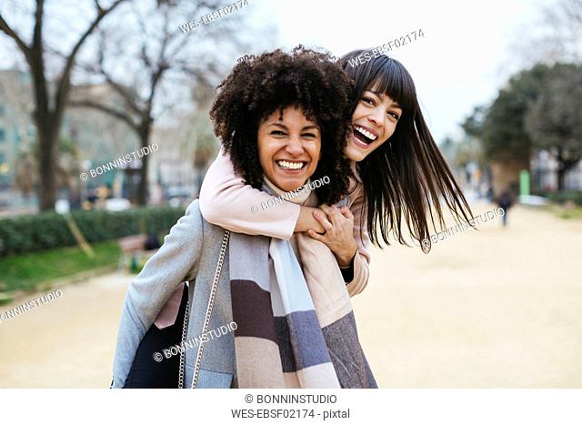 Spain, Barcelona, portrait of two exuberant women in city park