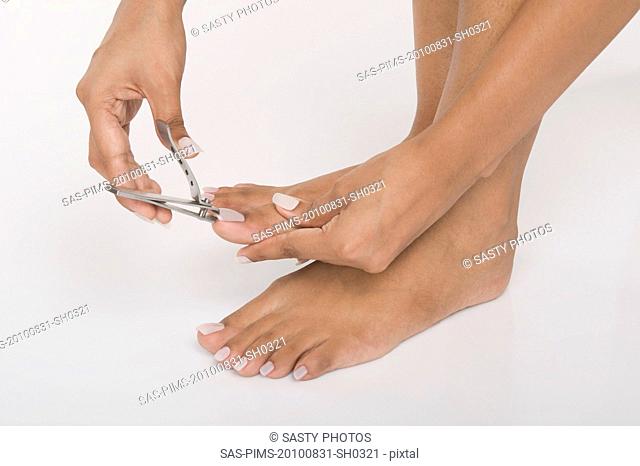 Woman clipping her toenails