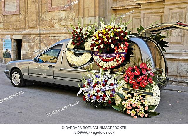 Hearse with mourning wreaths in front of the church at a funeral, basilica Santa Maria, Elx, Elche, Costa Blanca, Spain