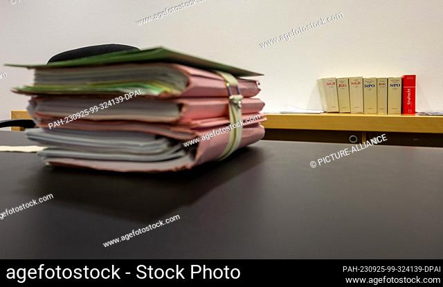 25 September 2023, Bavaria, Augsburg: In the district court, case files lie on the judge's table next to law books. The defendant is a tree inspector for the...