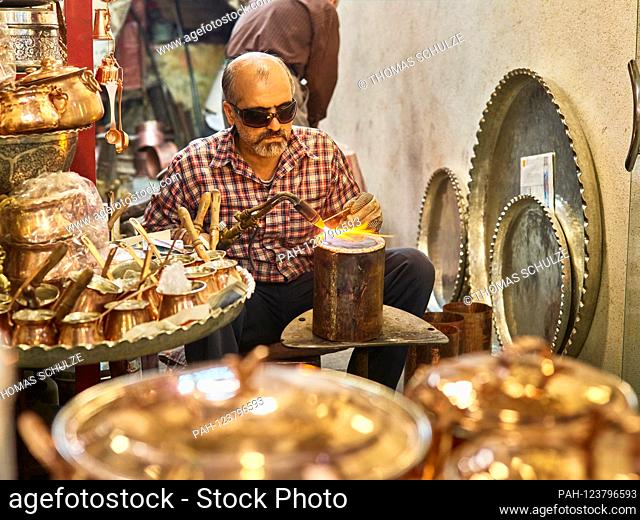 A coppersmith in the grand bazaar of the city of Isfahan in southern Iran, taken on April 23, 2017. The bazaar (Bazar-e Qeysariyeh or Bazar-e Bozorg) at Imam...