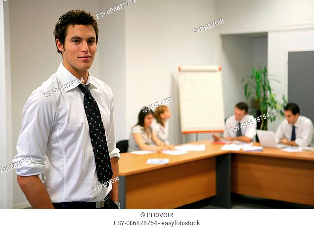 Young businessman about to give presentation to executives