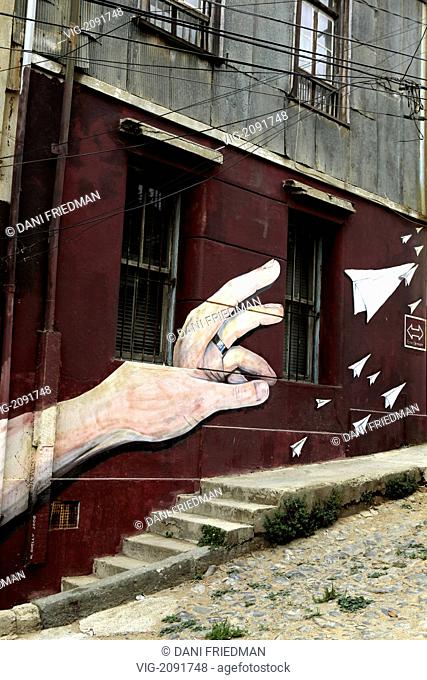 A mural of a left hand wearing a wedding band and throwing paper airplanes on a wall in Valparaiso. - VALPARAISO, VALPARAISO, CHILE, 10/03/2010