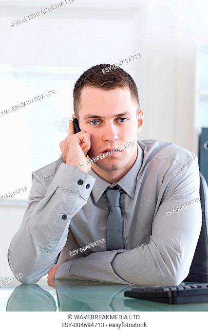 Businessman getting a serious call on his cellphone