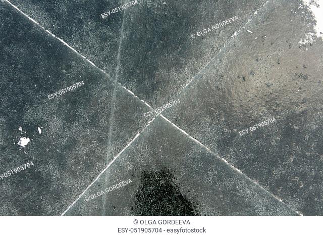 View of beautiful drawings on ice from cracks and bubbles of deep gas on the surface of lake Teletskoye , Russia