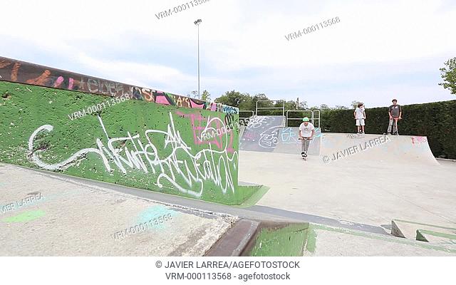 Teenager with city scooter in Skate park, Leioa, Bizkaia, Basque Country, Spain