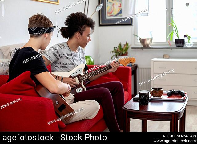 Young people playing guitars