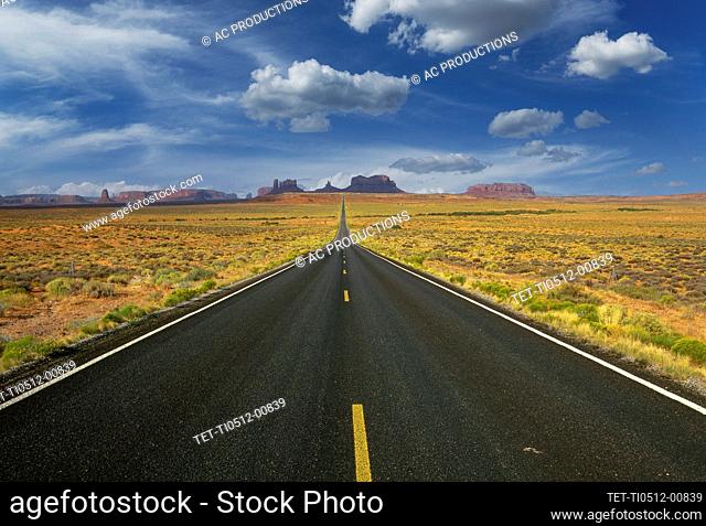 Arizona, Monument Valley Tribal Park, Empty road in desert leading to Monument Valley