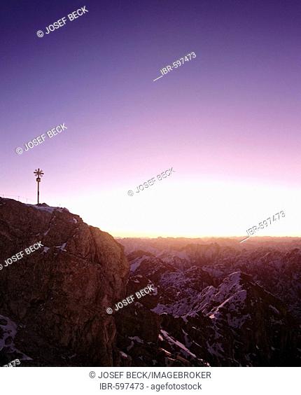 Summit cross at 2962 m or 9718 ft on the Zugspitze, Germany's highest mountain, at dawn, Wetterstein Range, Werdenfels Region, Upper Bavaria, Bavaria, Germany