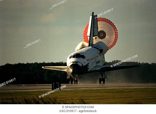 10/06/1997 -- The orbiter drag chute deploys after the Space Shuttle orbiter Atlantis lands on Runway 15 of the KSC Shuttle Landing Facility SLF at the...