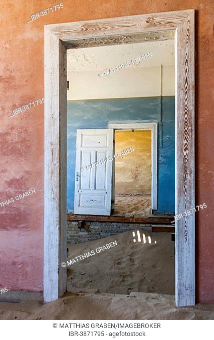 Wind-borne sand in a house of the former diamond miners settlement that is slowly covered by the sand of the Namib Desert, Kolmanskop, ?Karas, Namibia