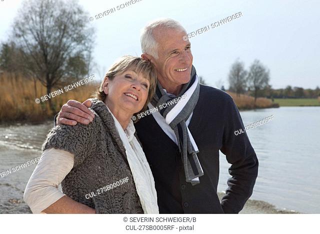 Senior couple walking by lake