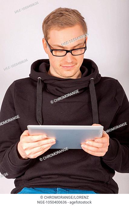 A young man working with a tablet PC