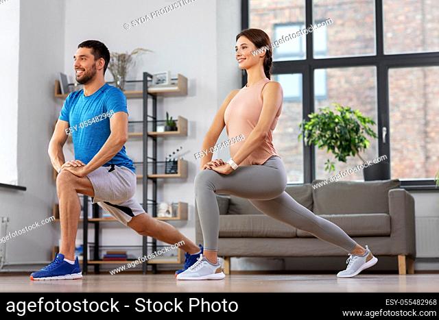 couple exercising and doing lunge at home