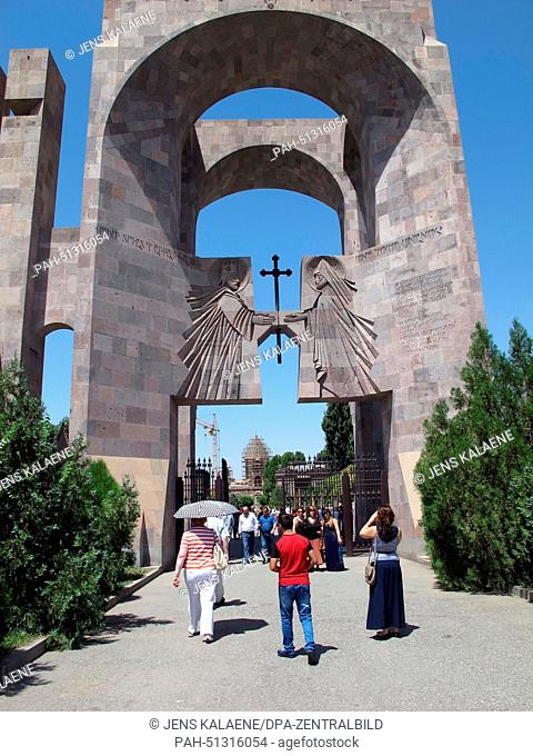 Visitors walk through the entrance portal leading toward the premises of the Cathedral of Etschmiadsin, also known as Mayr Tajar Surb Etschmiadsin (the church...