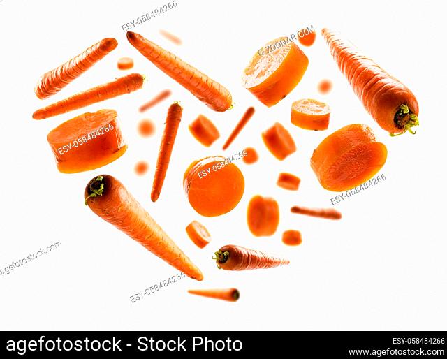 Ripe carrots in the shape of a heart on a white background