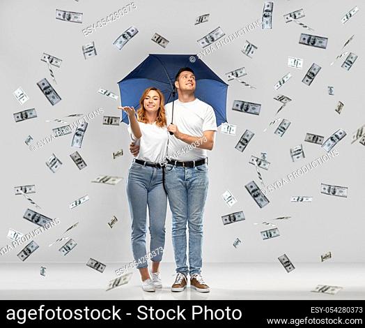 happy couple with umbrella standing money rain