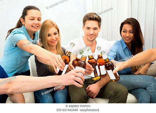Group Of Friends Toasting Beer Bottles